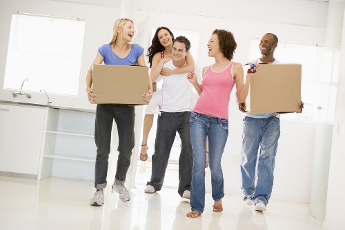 Student removals team handling boxes and furniture in a Tooting residential street