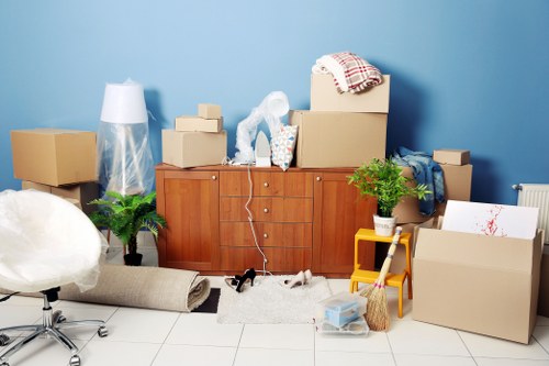 Removal team handling furniture in a Tooting residential move