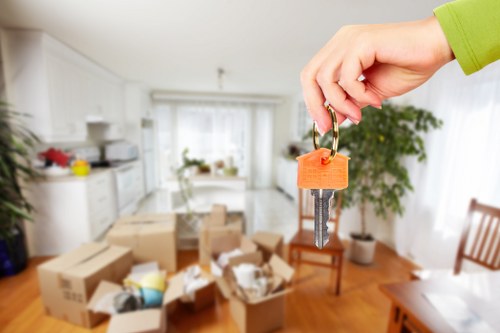Professional movers carrying boxes and furniture for a Tooting house move
