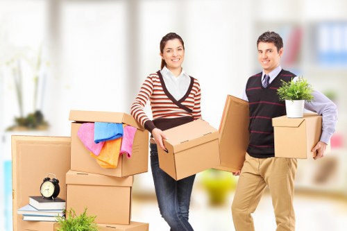 Removal team planning a flat move in Tooting with boxes and furniture