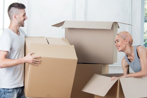 Movers carrying furniture carefully from a Tooting home
