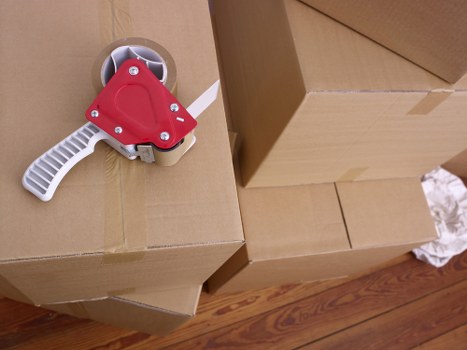 Student move preparation with labelled boxes and household items in Tooting